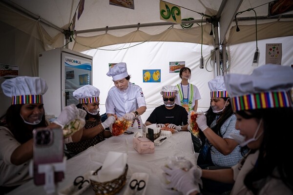 International participants making kimchi at the festival workshop zone