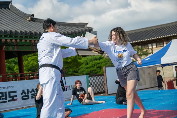 International visitors learning taekwondo basics